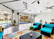 Thumbnail 21 of 27 - A Living Room with a Blue Couch at Flats on Chapel Apartments, Waco, 76712
