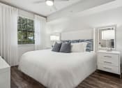 Thumbnail 19 of 41 - a bedroom with a bed and a window  at Barcelona Jupiter, Jupiter, FL