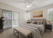 Thumbnail 3 of 23 - a bedroom with a bed and a ceiling fan