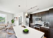 Thumbnail 4 of 22 - a kitchen with a white counter top at Glenwood at Grant Park Apartments, Georgia, 30316