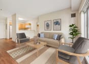 Thumbnail 7 of 23 - a living room with a couch and two chairs at the Residences at Manchester Place in Manchester, New Hampshire