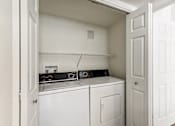 Thumbnail 9 of 27 - a washer and dryer in a laundry room with a white door at Altezza High Desert, Albuquerque, NM, 87111
