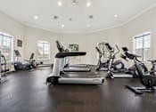 Thumbnail 17 of 23 - Free weights and fitness equipment in the 24 hour gym at Ballantrae Apartments