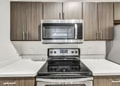 Thumbnail 15 of 31 - Deluxe Kitchen with Stainless Steel Appliances at River Stone Ranch, Austin, TX, 78749