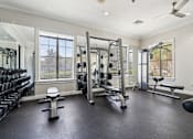 Thumbnail 16 of 23 - Free weights and fitness equipment in the 24 hour gym at Ballantrae Apartments
