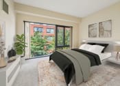 Thumbnail 8 of 23 - a bedroom with a bed and a large window at Residences at Manchester Place in Manchester New Hampshire