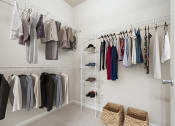 Thumbnail 9 of 31 - a closet with a rack of clothes in it and at Grandeville on Saxon, Orange City, Florida