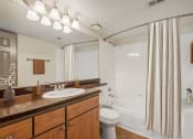 Thumbnail 9 of 23 - a bathroom with a sink and a toilet and a shower