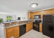 Thumbnail 3 of 21 - a kitchen with black appliances and granite counter tops at Gateway Club, Boynton Beach, 33436