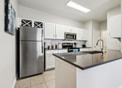 Thumbnail 1 of 27 - A Kitchen with a Refrigerator at Flats on Chapel Apartments, Waco, 76712