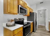 Thumbnail 1 of 31 - a kitchen with stainless steel appliances and wooden cabinets
