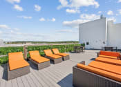 Thumbnail 23 of 23 - a rooftop deck with orange lounge chairs  at the Residences at Manchester Place in Manchester, New Hampshire