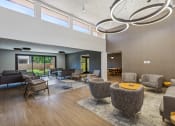 Thumbnail 25 of 33 - a large living room with chairs and tables and a large window at Acacia Gardens, Albuquerque, NM, 87111