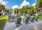 Thumbnail 13 of 28 - Outdoor grilling station with lounge chairs