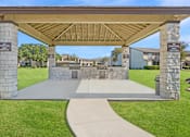 Thumbnail 12 of 23 - A covered walkway leads to a building with a sign that reads