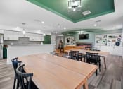 Thumbnail 20 of 33 - a clubroom kitchen with a large table and chairs at Edgebrook Residences, Merrimack New Hampshire