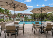 Thumbnail 15 of 30 - Poolside Seating at Cypress Shores, Coconut Creek, Florida