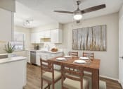 Thumbnail 2 of 33 - an open kitchen and dining room with a table and chairs at Acacia Gardens, Albuquerque, NM