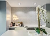 Thumbnail 13 of 23 - coffee station on top a white countertop in the clubroom at the Residences at Manchester Place in Manchester, New Hampshire