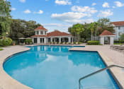 Thumbnail 13 of 30 - a large swimming pool with a clubhouse in the background at Cypress Shores, Coconut Creek, 33063