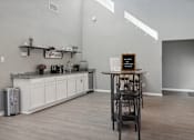 Thumbnail 17 of 23 - A bar area with a white counter and a black stool.