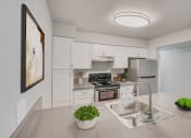 Thumbnail 1 of 12 - a kitchen with white cabinetry and stainless steel appliances at 2300 West Apartments, Reno, NV