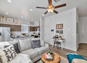 Thumbnail 4 of 43 - a living room with a couch and a ceiling fan