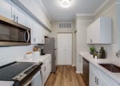 Thumbnail 3 of 30 - Kitchen with white cabinetry at Ashlar, Fort Myers