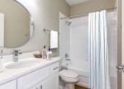 Thumbnail 8 of 29 - Bathroom equipped with sink, vanity, toilet, and full shower/bath