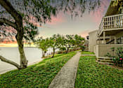 Thumbnail 17 of 18 - Lush Green Courtyard Wit Walking Paths at The Bay Club, Corpus Christi, TX, Texas