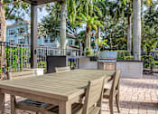 Thumbnail 28 of 41 - A wooden table and chairs are set up on a patio.