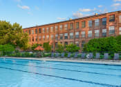 Thumbnail 19 of 33 - Pool with lounge chairs at Bigelow Commons, Enfield