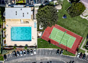 Thumbnail 11 of 25 - A tennis court is located next to a swimming pool.