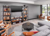 Thumbnail 27 of 40 - a living room with a gray couch and a coffee table at Maven on Broadway, Rochester, MN
