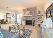 Thumbnail 6 of 21 - Living room with fireplace at High Oaks, Austin, Texas