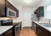 Thumbnail 5 of 14 - Renovated kitchen with stainless steel appliances at Canyon Creek, Austin, Texas