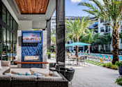 Thumbnail 24 of 35 - Outdoor lounge area with TV  | District at Rosemary at The District at Rosemary, Sarasota, FL