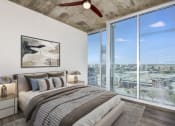Thumbnail 8 of 27 - a bedroom with a large window and a ceiling fan at Element, Tampa, 33602