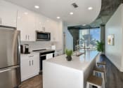 Thumbnail 1 of 27 - renovated home | kitchen with white cabinets, white quartz countertops, stainless steel appliances at Element, Tampa, 33602