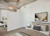 Thumbnail 5 of 27 - a bedroom with a bed and a couch in a 555 waverly unit at Element, Tampa, 33602