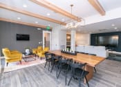 Thumbnail 4 of 40 - a conference room with a long wooden table and black chairs at Emblem Alpharetta, Alpharetta, 30009