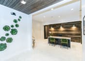 Thumbnail 7 of 40 - a dining room with a long table and green chairs at Emblem Alpharetta, Alpharetta, 30009