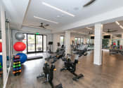 Thumbnail 10 of 40 - a spacious gym with cardio equipment and a variety of exercise balls at Emblem Alpharetta, Alpharetta, 30009