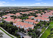 Thumbnail 35 of 38 - A large housing complex with red roofs and white walls.