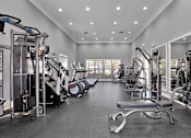 Thumbnail 18 of 38 - A spacious gym with a variety of equipment.