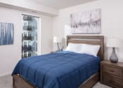 Thumbnail 6 of 40 - a bedroom with a bed and a painting on the wall at Maven on Broadway, Minnesota, 55904