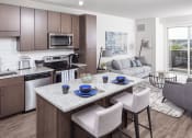 Thumbnail 2 of 40 - an open kitchen and living room with a marble counter top at Maven on Broadway, Minnesota