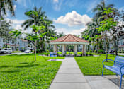 Thumbnail 22 of 41 - A park with a gazebo, benches, and trees at Floresta apartments in Jupiter, FL