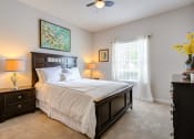 Thumbnail 12 of 14 - a bedroom with a bed and a ceiling fan at Thornberry Apartments, North Carolina