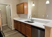 Thumbnail 10 of 31 - an empty kitchen with a sink and a refrigerator